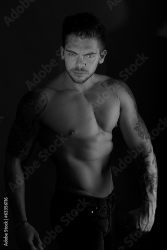 muscular man shot in dark background