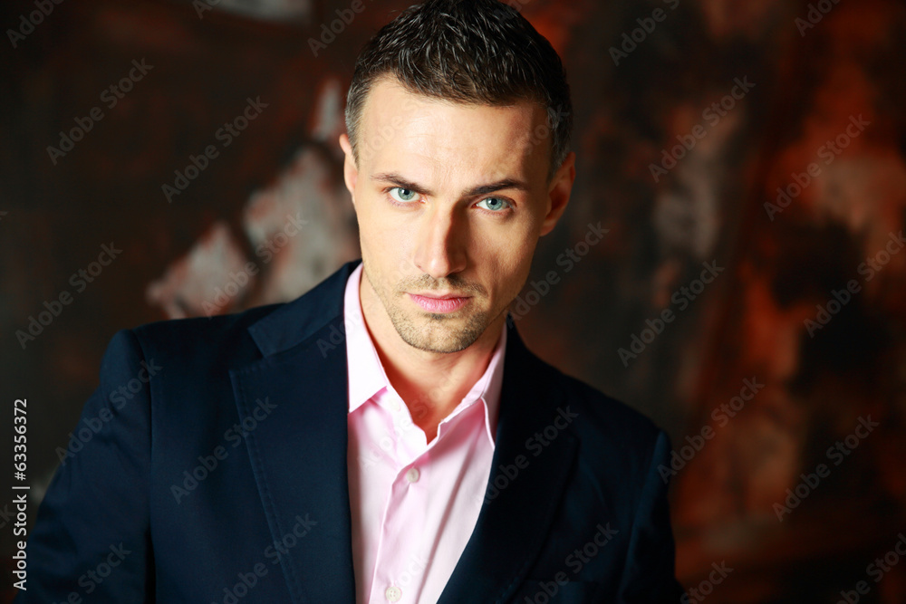 Portrait of a fashion man over industrial background Portrait of a fashion man over industrial background
