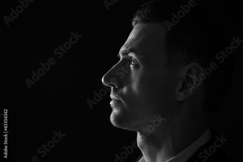 Fotografie Closeup portrait of a thoughtful man. Black and white photo.