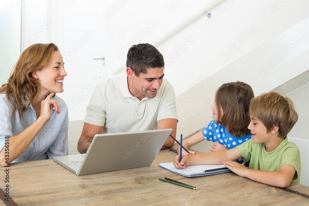 Parents with laptop assisting children coloring Parents with laptop assisting children coloring