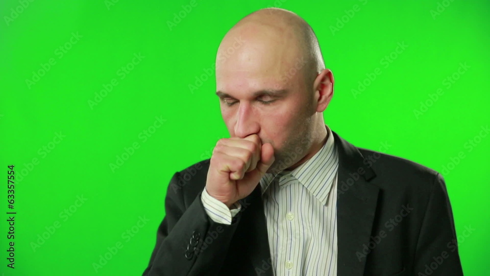 Sick businessman coughing against a green screen Sick businessman coughing against a green screen