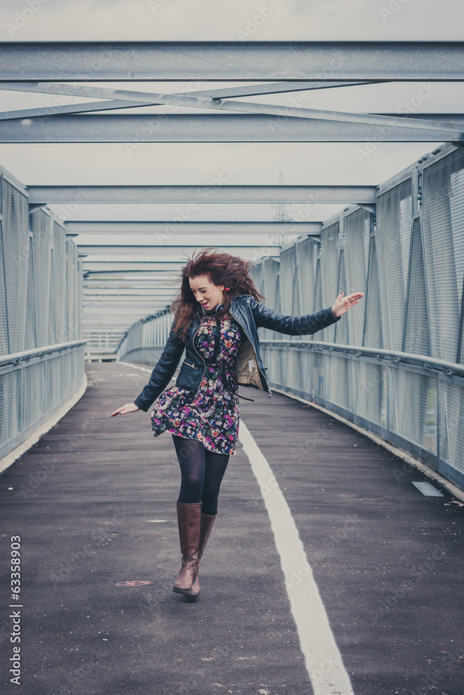 Pretty girl walking happy on a bridge Pretty girl walking happy on a bridge