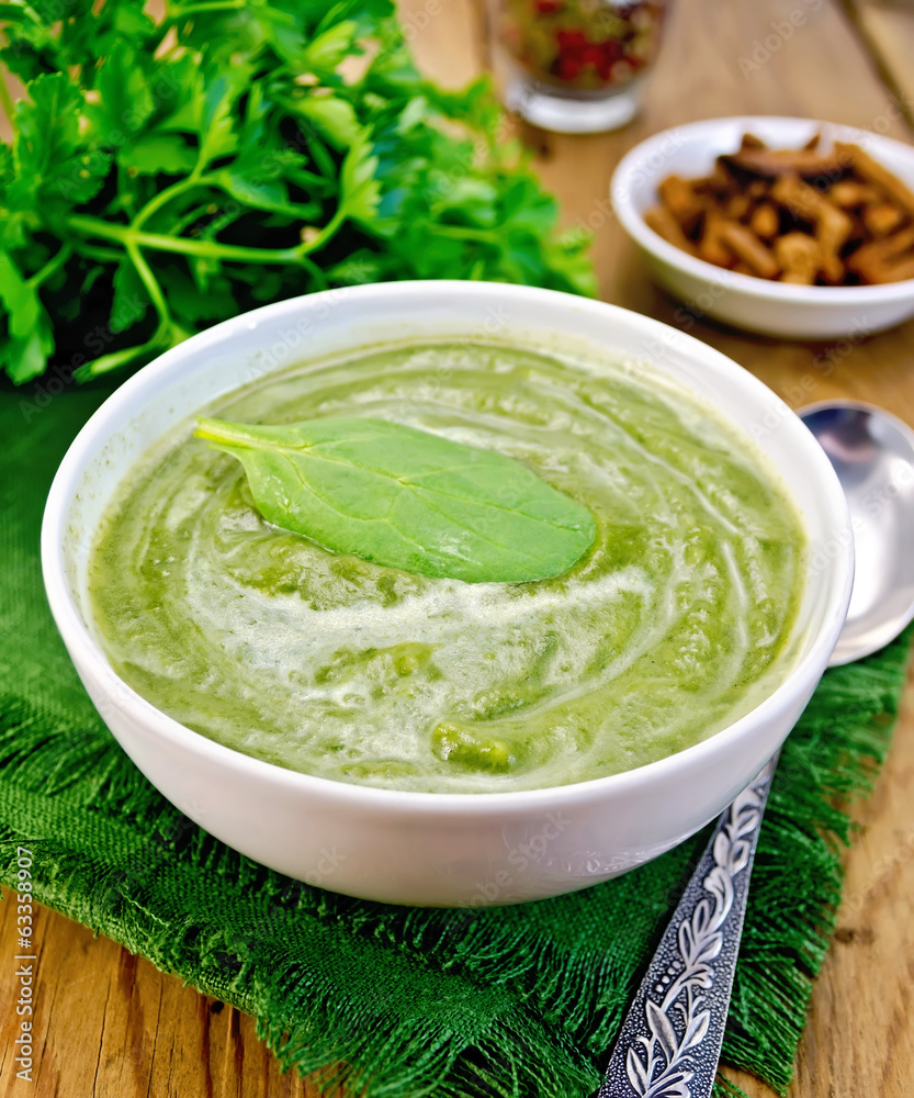 Puree green with spinach and spoon on board Puree green with spinach and spoon on board