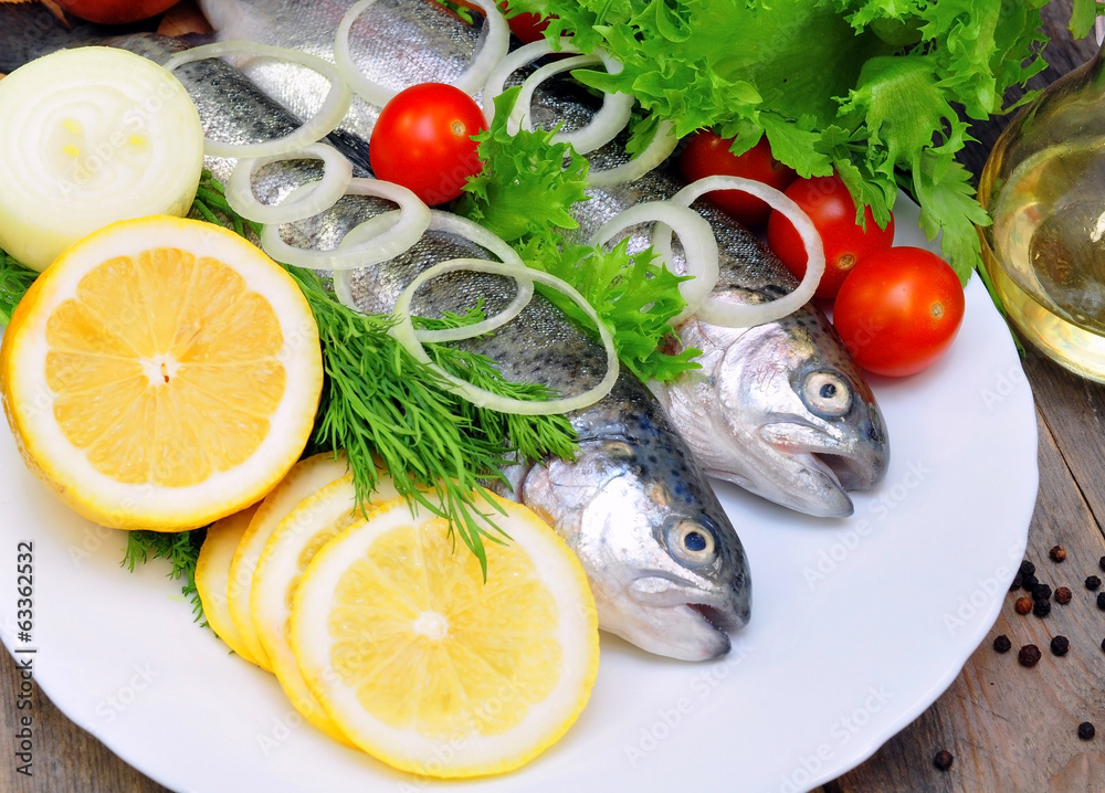 two rainbow trout with lemon and fresh vegetables two rainbow trout with lemon and fresh vegetables