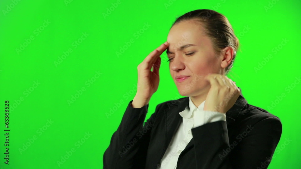 Young woman with headache against a green screen Young woman with headache against a green screen