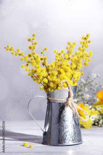 Fototapeta Naklejka Na Ścianę i Meble -  Twigs of mimosa flowers in vase on wooden table