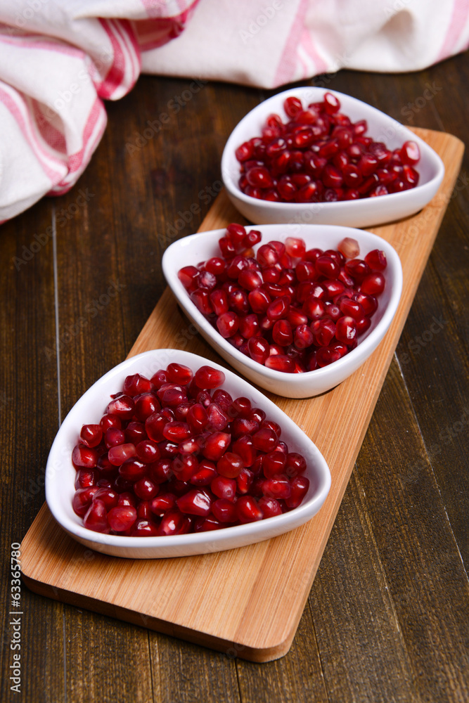 Ripe pomegranates on table close-up Ripe pomegranates on table close-up
