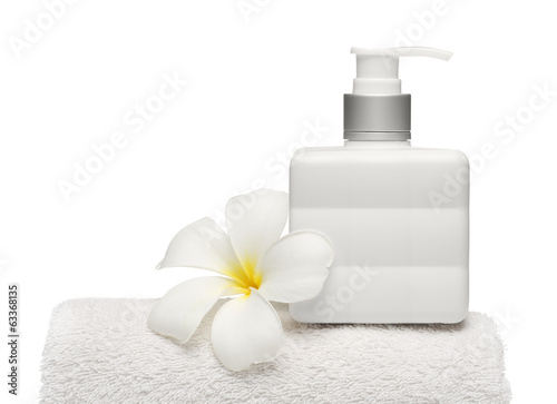 square bottle soap and flower on white towel white background