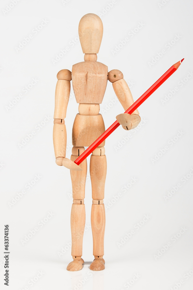 Small wood mannequin standing with colour pencil isolated on whi Small wood mannequin standing with colour pencil isolated on whi