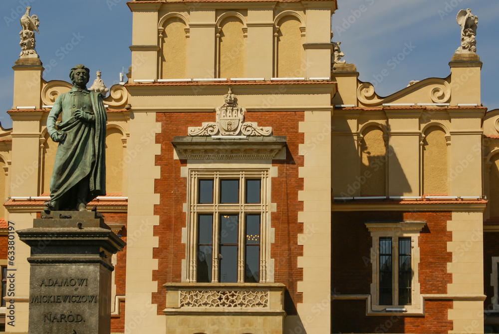 The statue of Adam Mickiewicz in front of the cloth hall in Krak - obrazy, fototapety, plakaty 