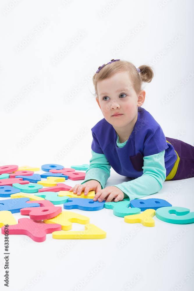 Little girl playing with letters and numbers Little girl playing with letters and numbers