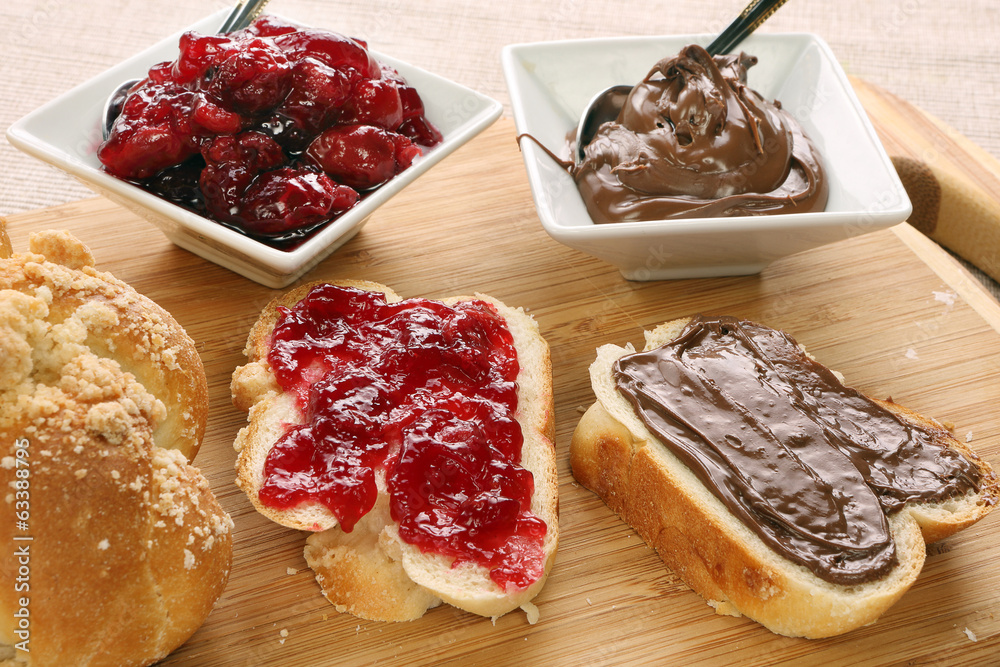 Obraz premium Sweet bread with cherry jam, and chocolate. Continental breakfas