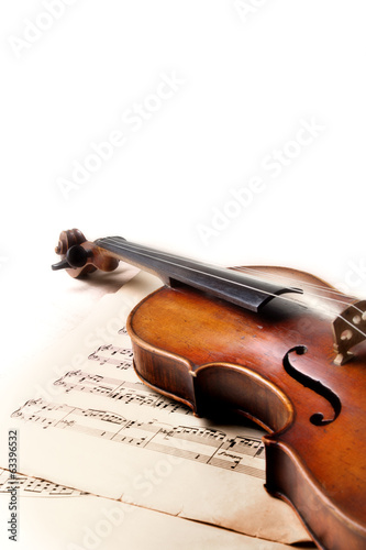 Old scratched violin on music sheet. White background.