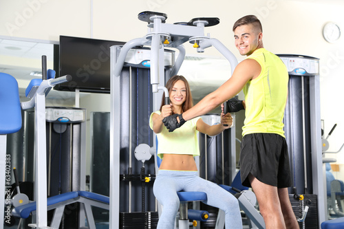 Girl and trainer engaged in...