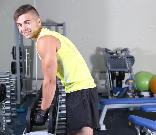 Guy with dumbbells in gym