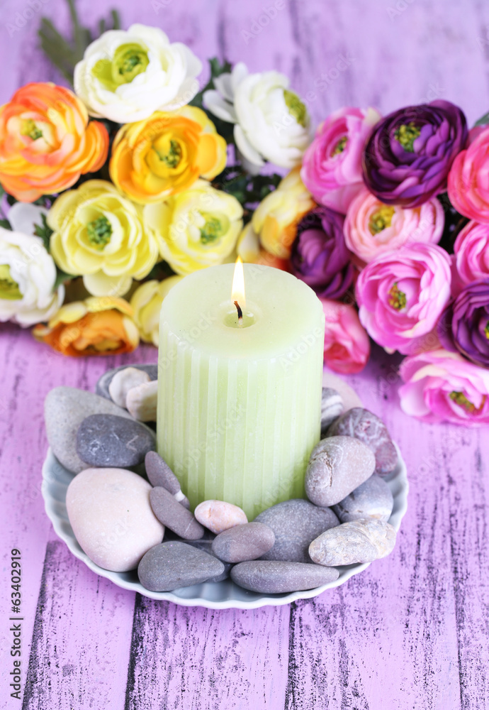 Composition with spa stones, candle and flowers Composition with spa stones, candle and flowers