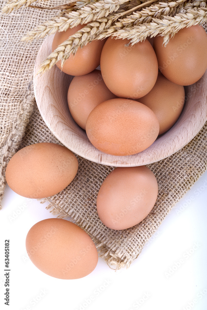 eggs in a wooden bowl on a linen canvas eggs in a wooden bowl on a linen canvas