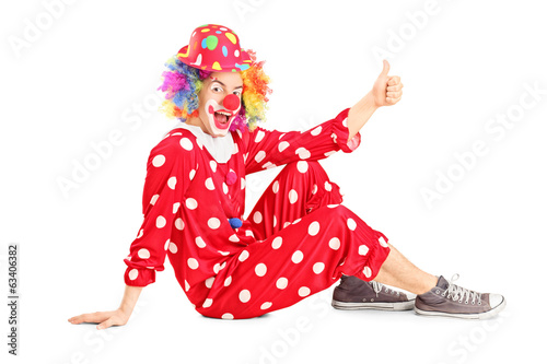 Clown sitting on the floor and giving thumb up