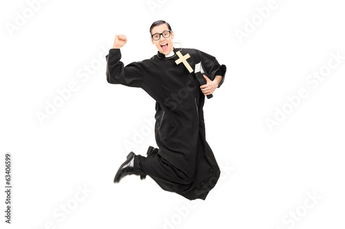 Excited male priest jumping with joy
