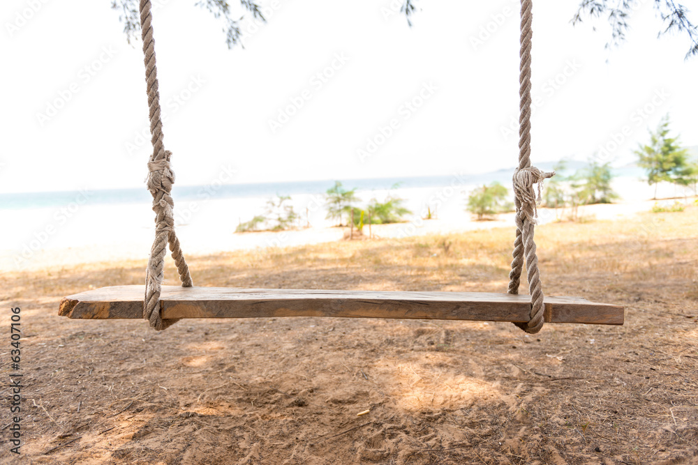 Swing hang from tree over beach
