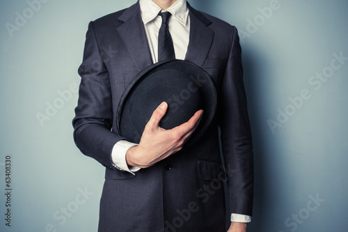 Принти на полотні Man holding a bowler hat