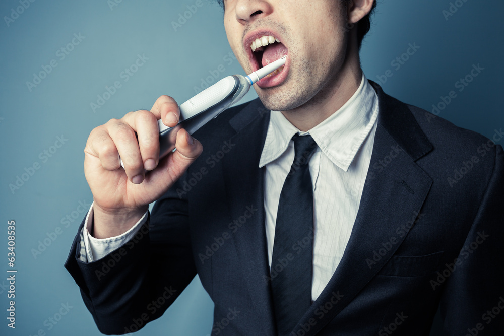 Businessman brushing his teeth Businessman brushing his teeth