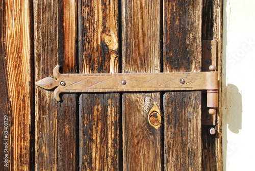 Rusted Hinge on Wooden Door