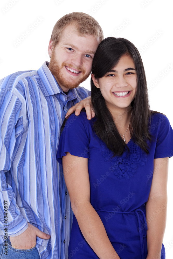 Happy young interracial couple in blue, early twenties or late t Happy young interracial couple in blue, early twenties or late t