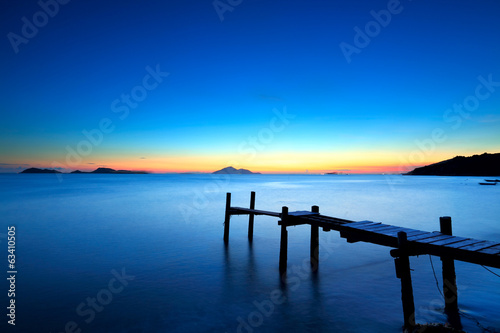 Wooden jetty with seascape during sunet © leungchopan