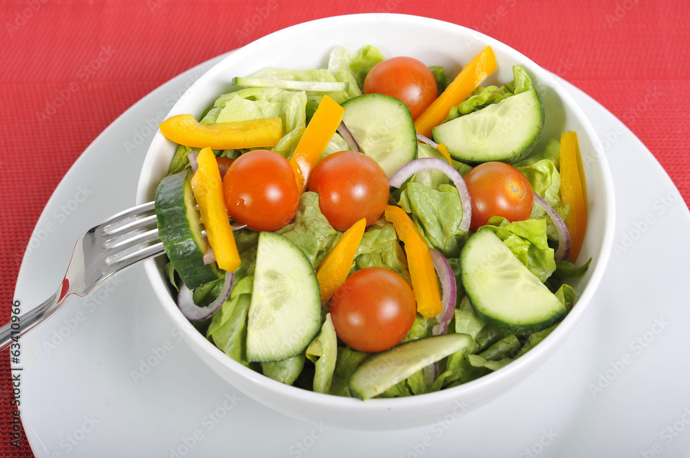 fork with cherry tomato, carrot in healthy salad bowl fork with cherry tomato, carrot in healthy salad bowl