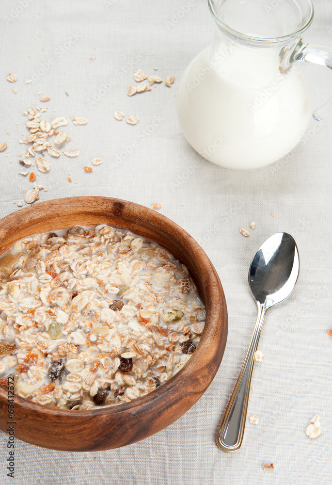 Muesli with raisin and fruits in wooden bowl Muesli with raisin and fruits in wooden bowl