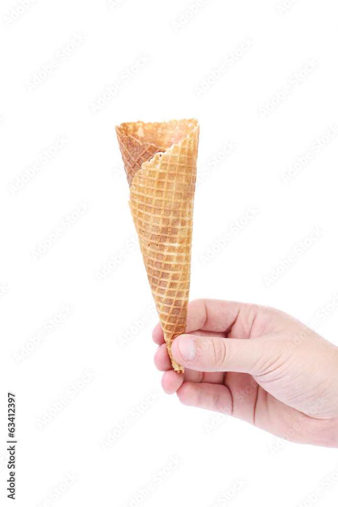 Hand holds empty ice cream corn