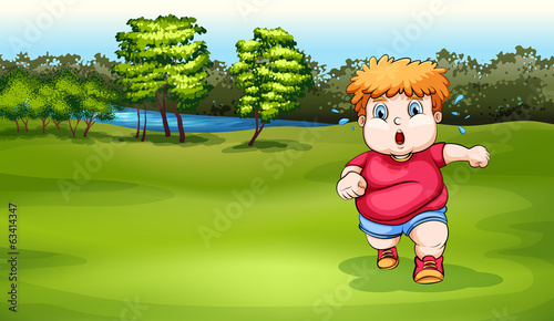 A boy jogging near the river