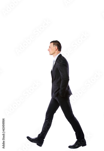 Side view portrait of a businessman walking