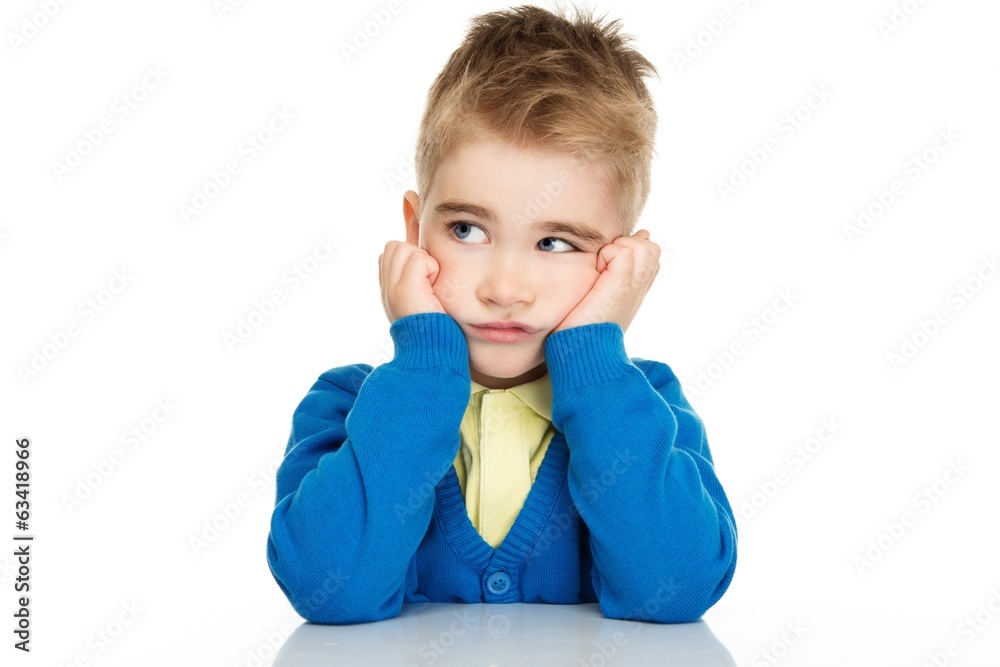 Thoughtful little boy in blue cardigan and yellow shirt Thoughtful little boy in blue cardigan and yellow shirt