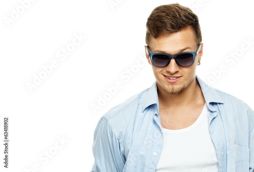 Stylish man in blue shirt wearing sunglasses isolated on white