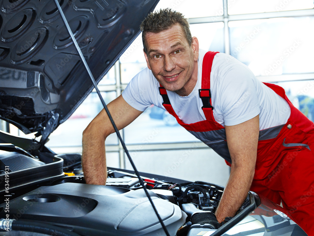 Master mechanic fixing the engine bay of a car Master mechanic fixing the engine bay of a car