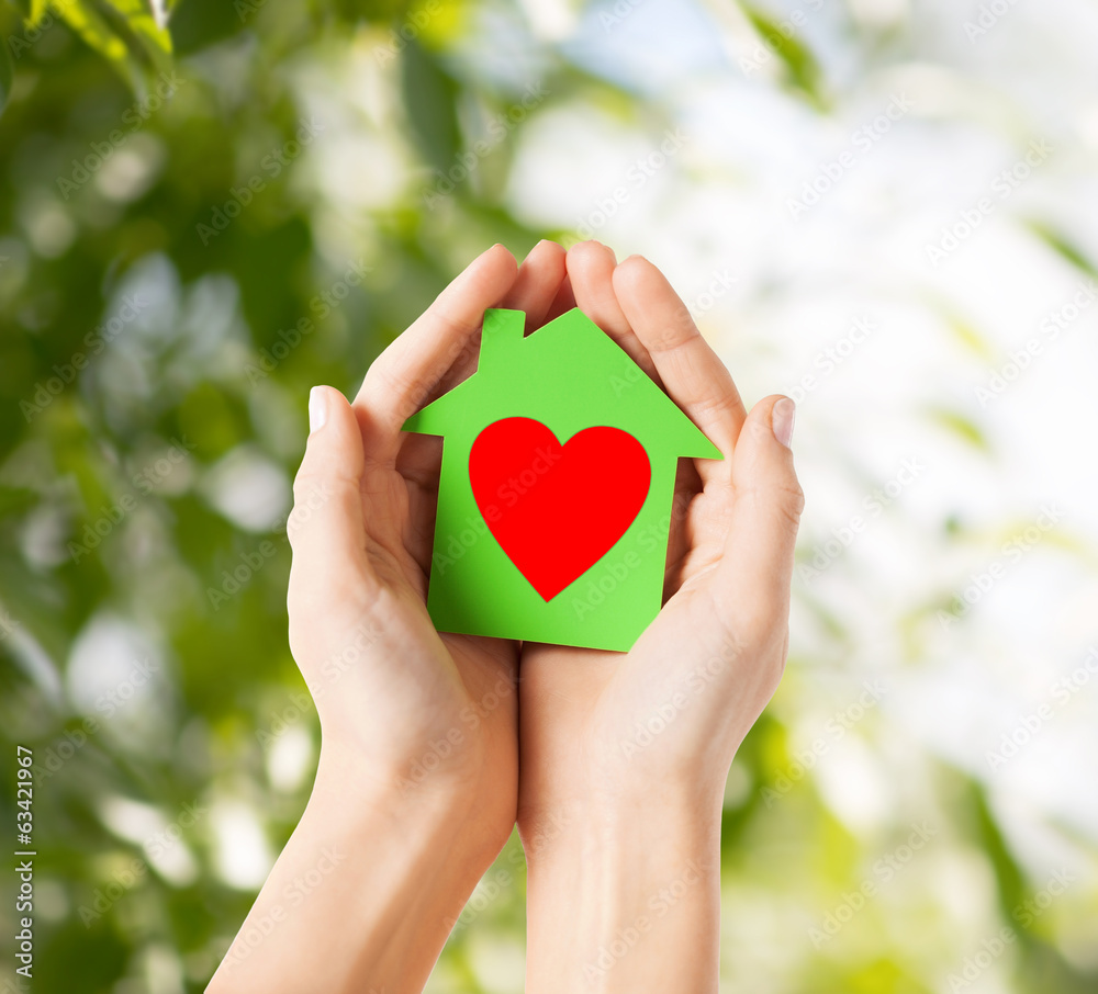 hands holding green paper house hands holding green paper house