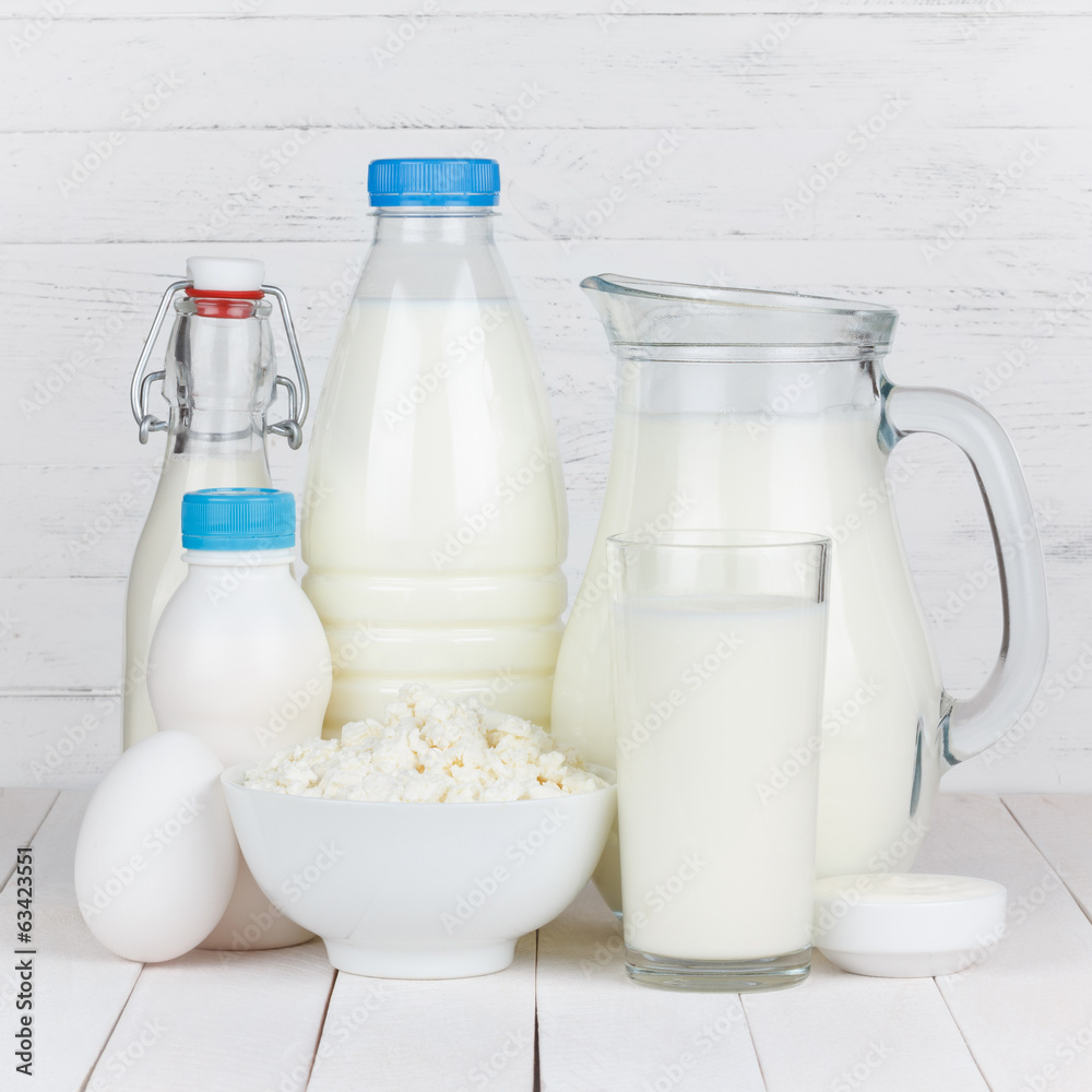 Dairy products isolated on white wooden table Dairy products isolated on white wooden table