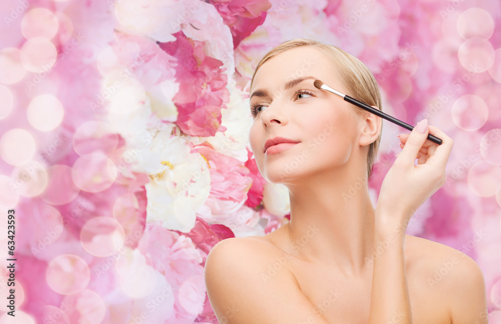 Fototapeta premium beautiful woman with makeup brush