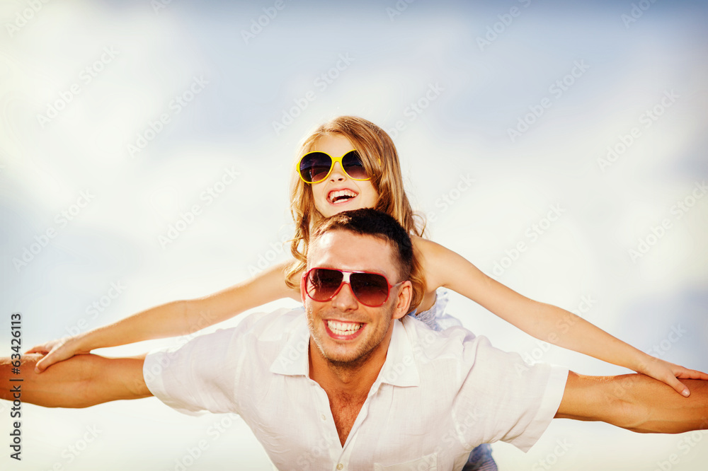 happy father and child in sunglasses over blue sky happy father and child in sunglasses over blue sky
