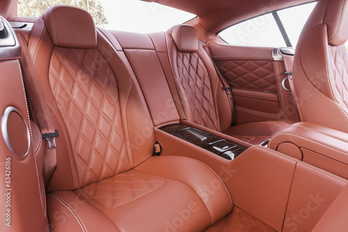 Red back passenger seats in modern luxury comfortable car