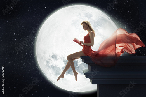 Cute woman over full moon background #63426783
