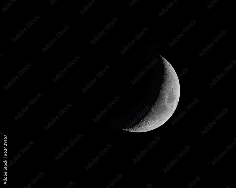 Naklejka premium Moon Phase isolated on black - Waxing Crecent