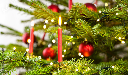 red candle in christmas tree