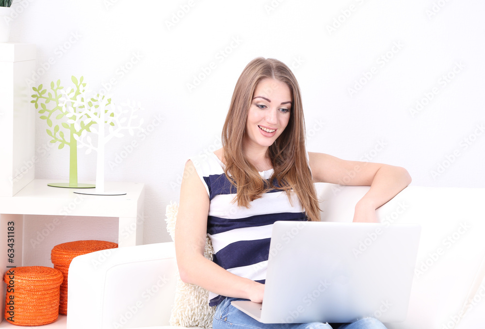 Young woman resting with laptop on sofa at home Young woman resting with laptop on sofa at home