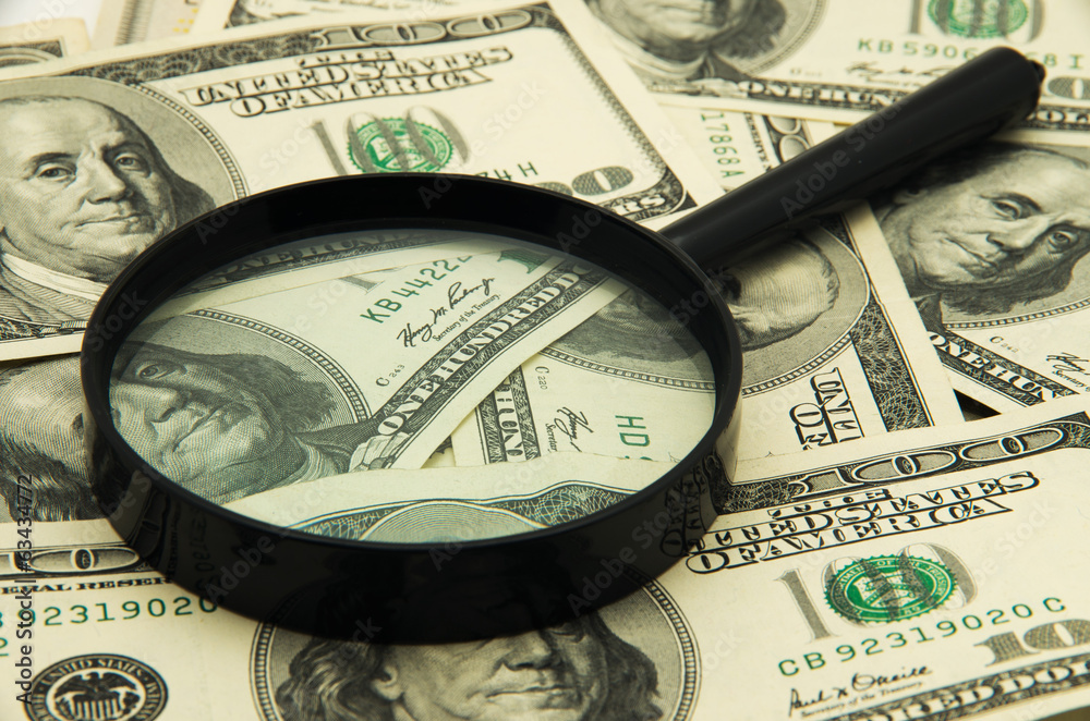 Magnifying glass and money