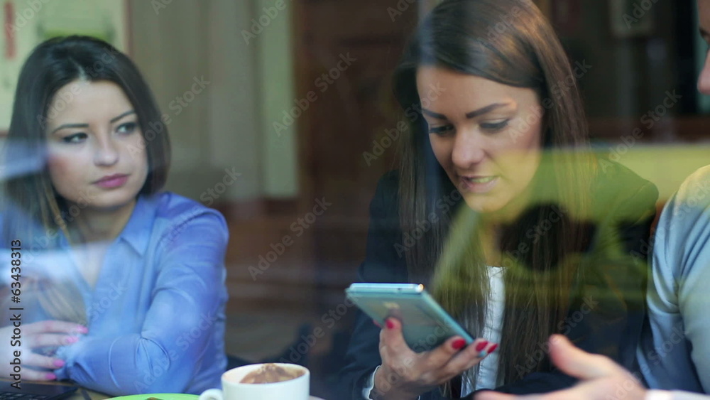Businesspeople looking on cellphone in cafe, steadycam shot Businesspeople looking on cellphone in cafe, steadycam shot
