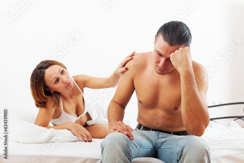Middle-aged man has problem, wife comforting him