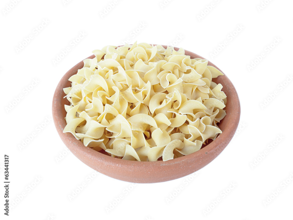Wide egg noodles in bowl of clay on white Wide egg noodles in bowl of clay on white